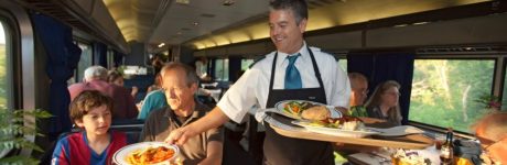 BCX1PP Aboard the California Zephyr Iowa A waiter serves dinner in a dining car on a transcontinental Amtrak train