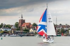 E88394 A sailboat usung a colourful spinnaker as  participates in the spectacular Parade of Sail at the Maldon Regatta in Essex.
